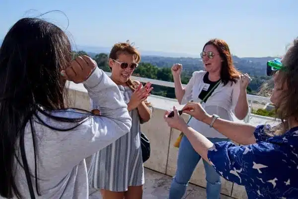 four women outdoors on a rooftop