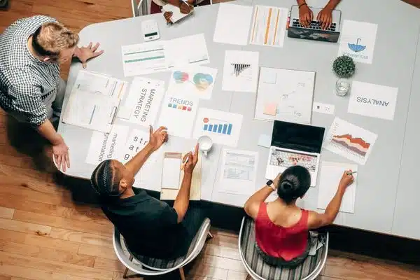 a shot of people working at a conference table from above