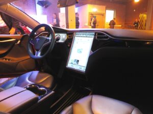 Front seat of a Tesla with a glowing screen