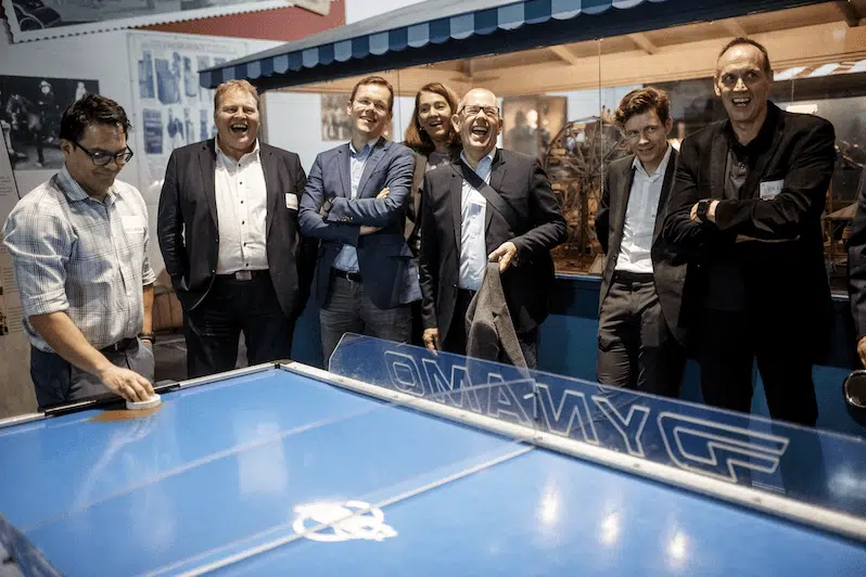 Group gathered around an air hockey table